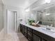 Bathroom with double sink vanity, quartz countertop, and a large mirror at 817 Great Sky Ct, North Las Vegas, NV 89084