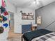 Cozy bedroom featuring modern gray accent wall, dresser, guitar, and view to hallway at 817 Great Sky Ct, North Las Vegas, NV 89084