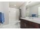 Bathroom featuring white bath, shower, and brown cabinets at 8255 Las Vegas Blvd # 1908, Las Vegas, NV 89123