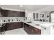 Modern kitchen with a breakfast bar, stainless steel appliances, and stylish dark wood cabinetry at 8255 Las Vegas Blvd # 1908, Las Vegas, NV 89123