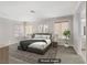 This staged main bedroom features neutral walls, carpet, an area rug, and multiple windows for natural light at 8313 Sky Canyon Ct, Las Vegas, NV 89128