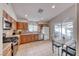 Traditional kitchen featuring oak cabinets, stainless steel appliances, and an adjacent dining area at 8519 Little Fox St, Las Vegas, NV 89123