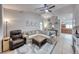 Cozy living room featuring tile flooring, ceiling fan, and seamless access to the kitchen at 8519 Little Fox St, Las Vegas, NV 89123