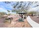 Outdoor picnic area with grill, ramada, picnic table, trash receptacle, and walking path at 8519 Little Fox St, Las Vegas, NV 89123