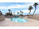 Community pool with palm trees, safety fence and several lounge chairs at 8519 Little Fox St, Las Vegas, NV 89123