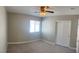 Comfortable bedroom with neutral carpeting, ceiling fan, and sliding door closet at 8635 Tomnitz Ave # 103, Las Vegas, NV 89178