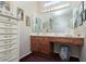 Vanity area with large mirror, makeup lighting, cabinets, drawers, and stool at 8904 Marble Dr, Las Vegas, NV 89134