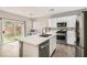 A modern kitchen features stainless steel appliances, white cabinetry, and a central island with a sink at 9241 Placer Bullion Ave, Las Vegas, NV 89178