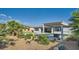 This backyard showcases the desert landscaping, grass, and pergola at 9475 W Rosada Way, Las Vegas, NV 89149