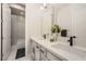 Modern bathroom with a double sink vanity, white cabinets, and a shower/tub combination at 9475 W Rosada Way, Las Vegas, NV 89149