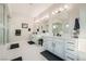 Bathroom boasts a double sink vanity with white cabinets and modern fixtures at 9475 W Rosada Way, Las Vegas, NV 89149
