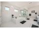 Bright bathroom features a soaking tub, glass shower, and elegant white tiling at 9475 W Rosada Way, Las Vegas, NV 89149