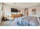 Bright bedroom with a cozy chaise lounge, dresser, and a modern, comfortable bed at 9475 W Rosada Way, Las Vegas, NV 89149