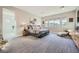 Spacious primary bedroom features plush carpet, lots of natural light, and neutral color palette at 9475 W Rosada Way, Las Vegas, NV 89149