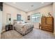 Cozy bedroom featuring a comfortable bed, stylish decor, and ample natural light at 9475 W Rosada Way, Las Vegas, NV 89149