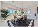 Bright dining room featuring modern chandelier, contemporary table set, and large windows at 9475 W Rosada Way, Las Vegas, NV 89149