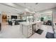 Spacious kitchen showcasing a large island with bar seating and flowing into the cozy living room at 9475 W Rosada Way, Las Vegas, NV 89149