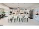Modern kitchen with stainless steel appliances, a large center island, and stylish pendant lighting at 9475 W Rosada Way, Las Vegas, NV 89149