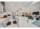 Open-concept kitchen featuring white cabinets, a spacious island, and seamless flow into the living area at 9475 W Rosada Way, Las Vegas, NV 89149