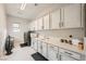 Well-equipped laundry room featuring modern appliances, bright lighting, and ample cabinet space at 9475 W Rosada Way, Las Vegas, NV 89149