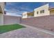 Private outdoor space with brick pavers, small turf area, gravel and block wall fence at 11940 Vector Ray Ave, Las Vegas, NV 89138