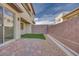 Private outdoor space with brick pavers, small turf area, gravel and block wall fence at 11940 Vector Ray Ave, Las Vegas, NV 89138