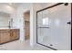 This modern bathroom features a glass enclosed shower, and a vanity with black hardware at 11940 Vector Ray Ave, Las Vegas, NV 89138