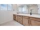 This modern bathroom features a double vanity with stone countertops and a large mirror at 11940 Vector Ray Ave, Las Vegas, NV 89138