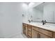 This bathroom features a double vanity with stone countertops and modern fixtures at 11940 Vector Ray Ave, Las Vegas, NV 89138