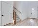 Bright entryway featuring wood-look flooring and an open staircase with modern wood and black metal railings at 11940 Vector Ray Ave, Las Vegas, NV 89138