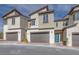Charming home exteriors featuring modern design with stone accents, a front-entry garage, and a pop of color from the front door at 11940 Vector Ray Ave, Las Vegas, NV 89138
