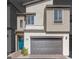 Beautiful two-story home featuring stone accents, a front-entry garage, and a pop of color from the turquoise front door at 11940 Vector Ray Ave, Las Vegas, NV 89138