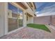 Private outdoor space with brick pavers, small turf area and block wall fence at 11940 Vector Ray Ave, Las Vegas, NV 89138