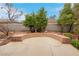 Backyard sitting area featuring brick border, mature landscaping, and privacy wall at 1433 Erskine Ave, Las Vegas, NV 89123