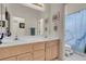 Bathroom with a double sink vanity, a full mirror, and a tub with a shower curtain at 1433 Erskine Ave, Las Vegas, NV 89123