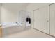 Well-lit bathroom showcases a tub, frosted glass shower, and closet with white doors at 1433 Erskine Ave, Las Vegas, NV 89123
