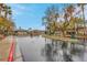 View of community entrance and gate with neatly landscaped grounds in a wet shot at 1433 Erskine Ave, Las Vegas, NV 89123
