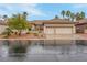 Lovely single story home featuring desert landscaping, a tile roof, and a two-car garage at 1433 Erskine Ave, Las Vegas, NV 89123