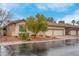 Charming single story home featuring desert landscaping, a tile roof, and a two-car garage at 1433 Erskine Ave, Las Vegas, NV 89123