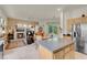 Open-concept kitchen with island, leading into a cozy living area with a fireplace at 1433 Erskine Ave, Las Vegas, NV 89123