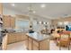Bright kitchen boasts a center island, wooden cabinetry, and a ceiling fan at 1433 Erskine Ave, Las Vegas, NV 89123