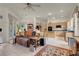 Cozy living room leading to a kitchen with stainless steel appliances and ample cabinet space at 1433 Erskine Ave, Las Vegas, NV 89123