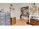 Additional office space with shelving, storage cabinets, and bright laminate flooring at 1433 Erskine Ave, Las Vegas, NV 89123