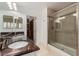 Updated bathroom with granite counters, double sinks, and a glass-enclosed tiled shower at 1605 Shadow Rock Dr, Las Vegas, NV 89117