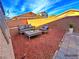 Backyard area with gravel, a patio with comfortable seating, and a brick wall offering privacy at 1630 Meadow Bluffs Ave, Henderson, NV 89014