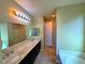 Spacious bathroom featuring double sinks, tiled flooring, and a separate tub at 1630 Meadow Bluffs Ave, Henderson, NV 89014