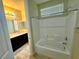 Bright bathroom with a shower and vanity with a stone countertop at 1630 Meadow Bluffs Ave, Henderson, NV 89014