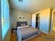 Bright bedroom with carpet, complemented by a convenient closet and a nearby bathroom, offers comfort and functionality at 1630 Meadow Bluffs Ave, Henderson, NV 89014