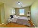Inviting bedroom showcasing carpet, a window with blinds, and a nightstand, creating a comfortable and serene setting at 1630 Meadow Bluffs Ave, Henderson, NV 89014