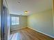 A bedroom with light-colored walls, wood flooring and a window at 1630 Meadow Bluffs Ave, Henderson, NV 89014